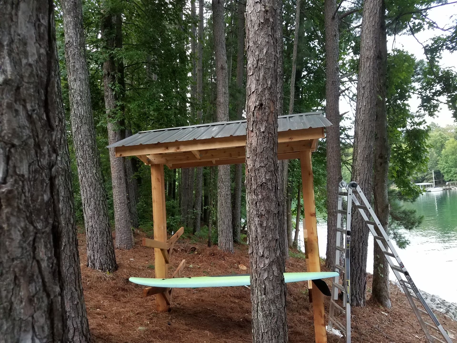 A wooden picnic table in the middle of a forest