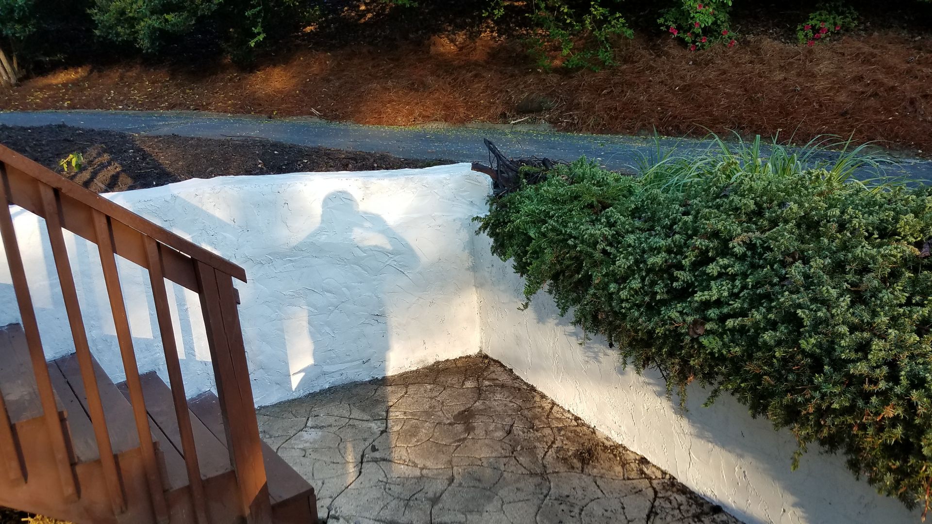 A wooden staircase leading up to a white wall