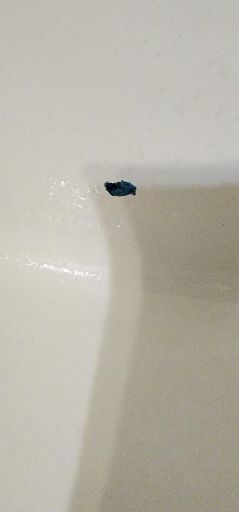 A close up of a bathtub with a hole in it.
