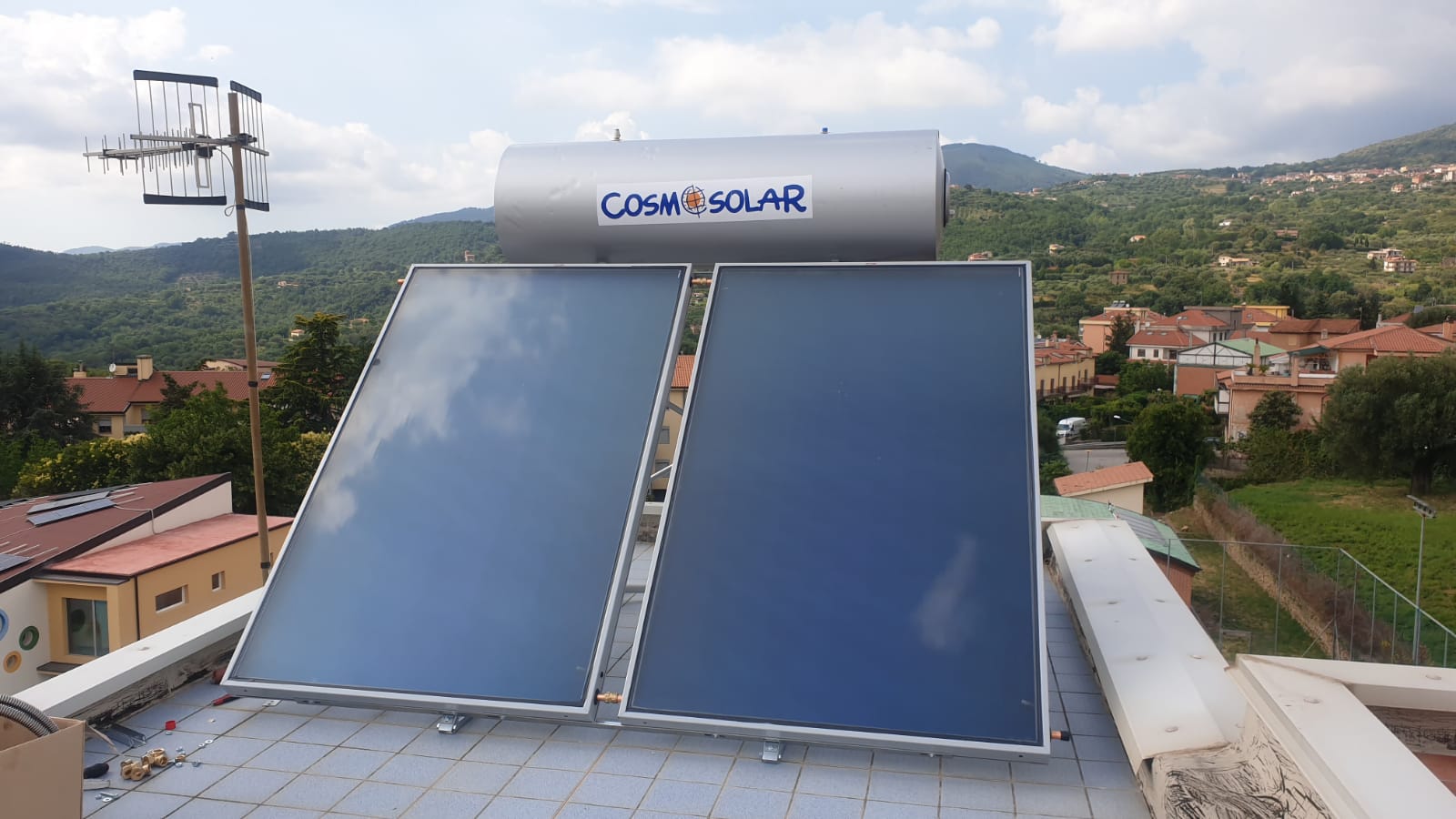 Uno scaldabagno solare è posizionato in cima a un tetto.