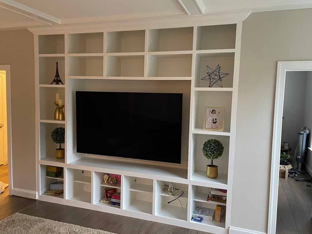A living room with a large flat screen tv mounted on the wall.