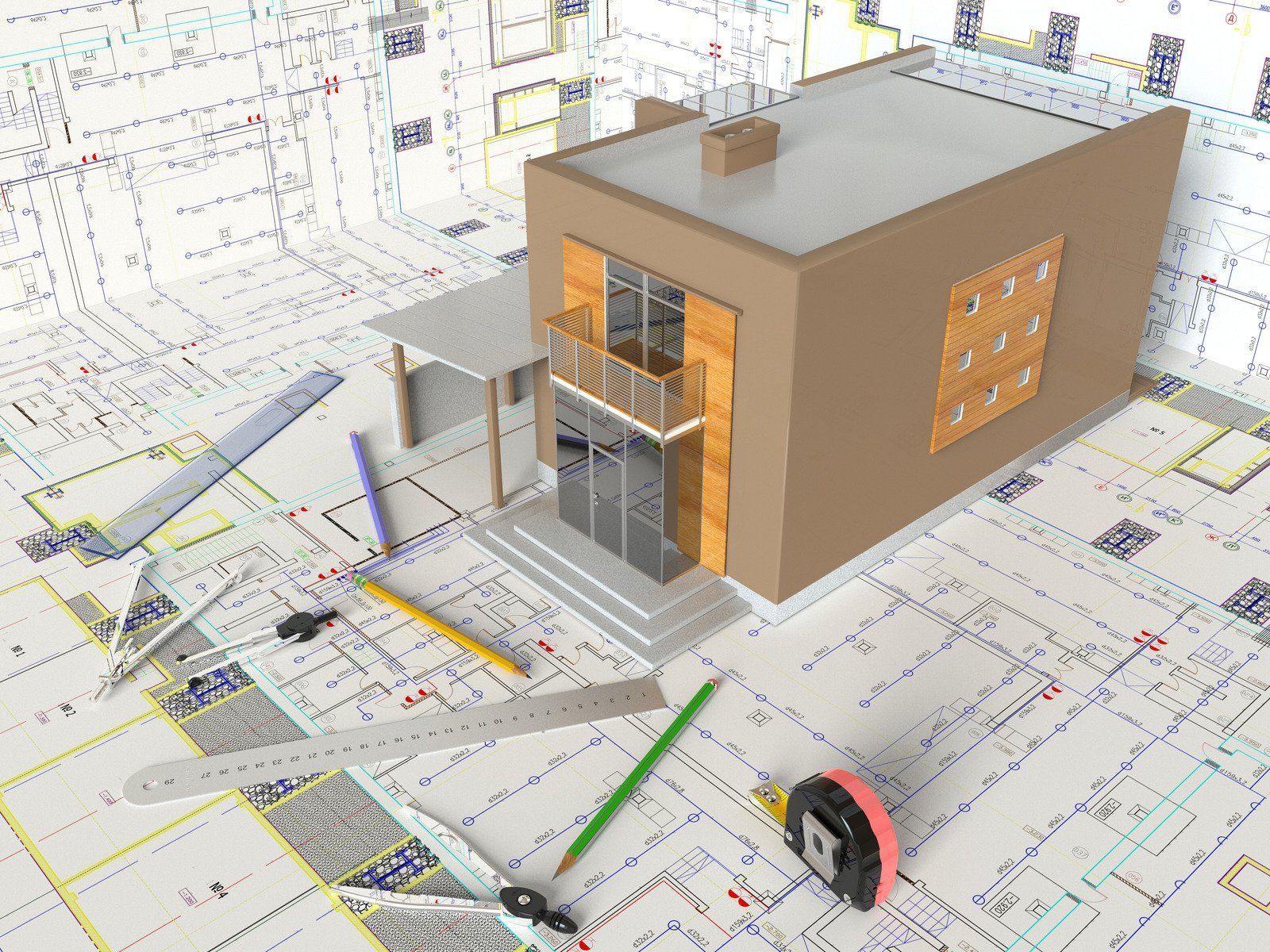 Architectural model of a house with blueprints, tools and materials spread around.