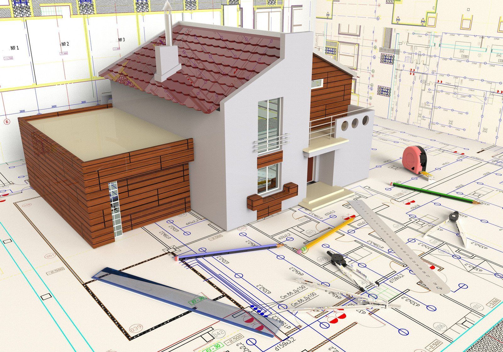 A model house rests on blueprints, surrounded by architectural tools.