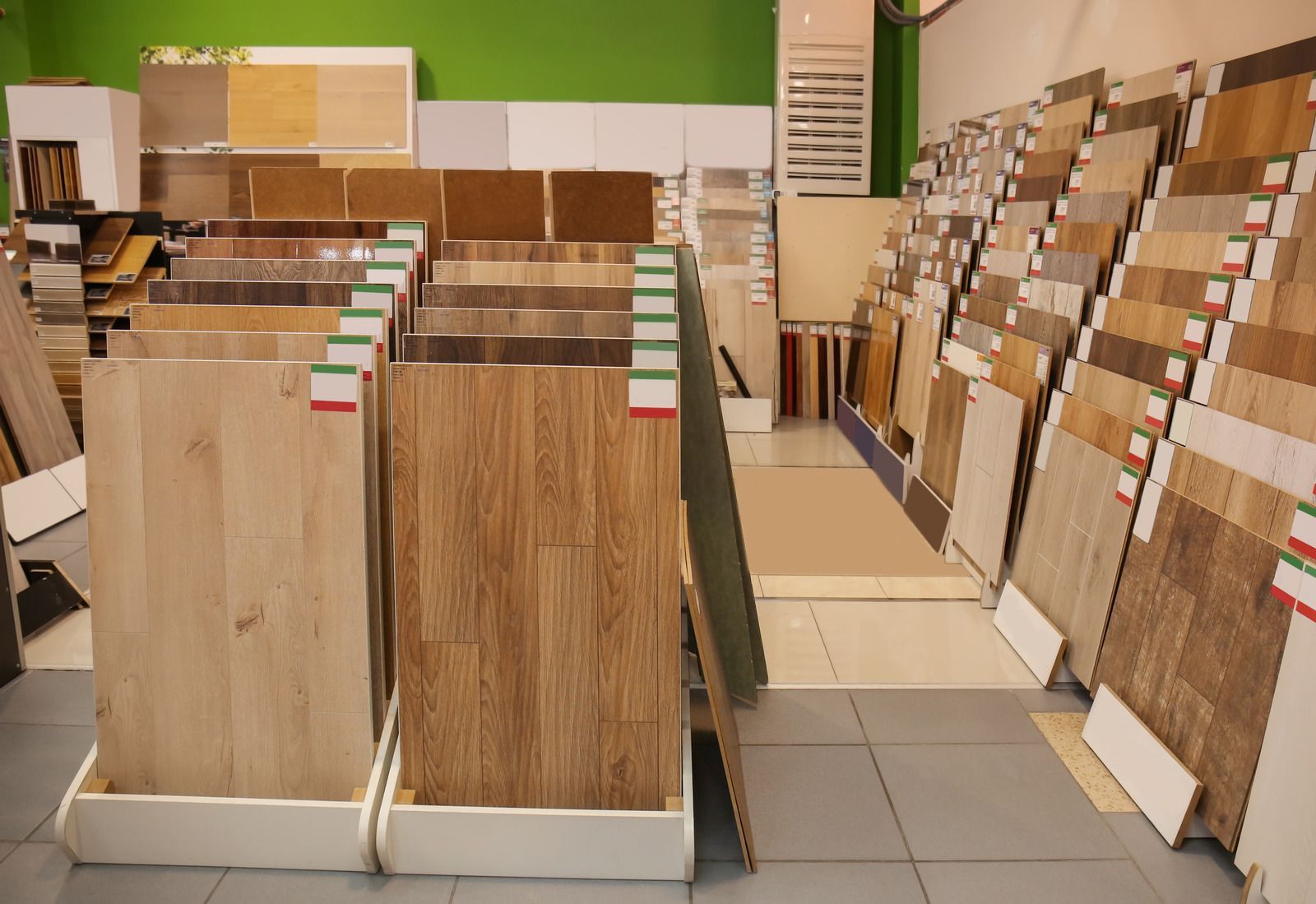 Flooring samples displayed in a showroom, featuring various wood and tile options.