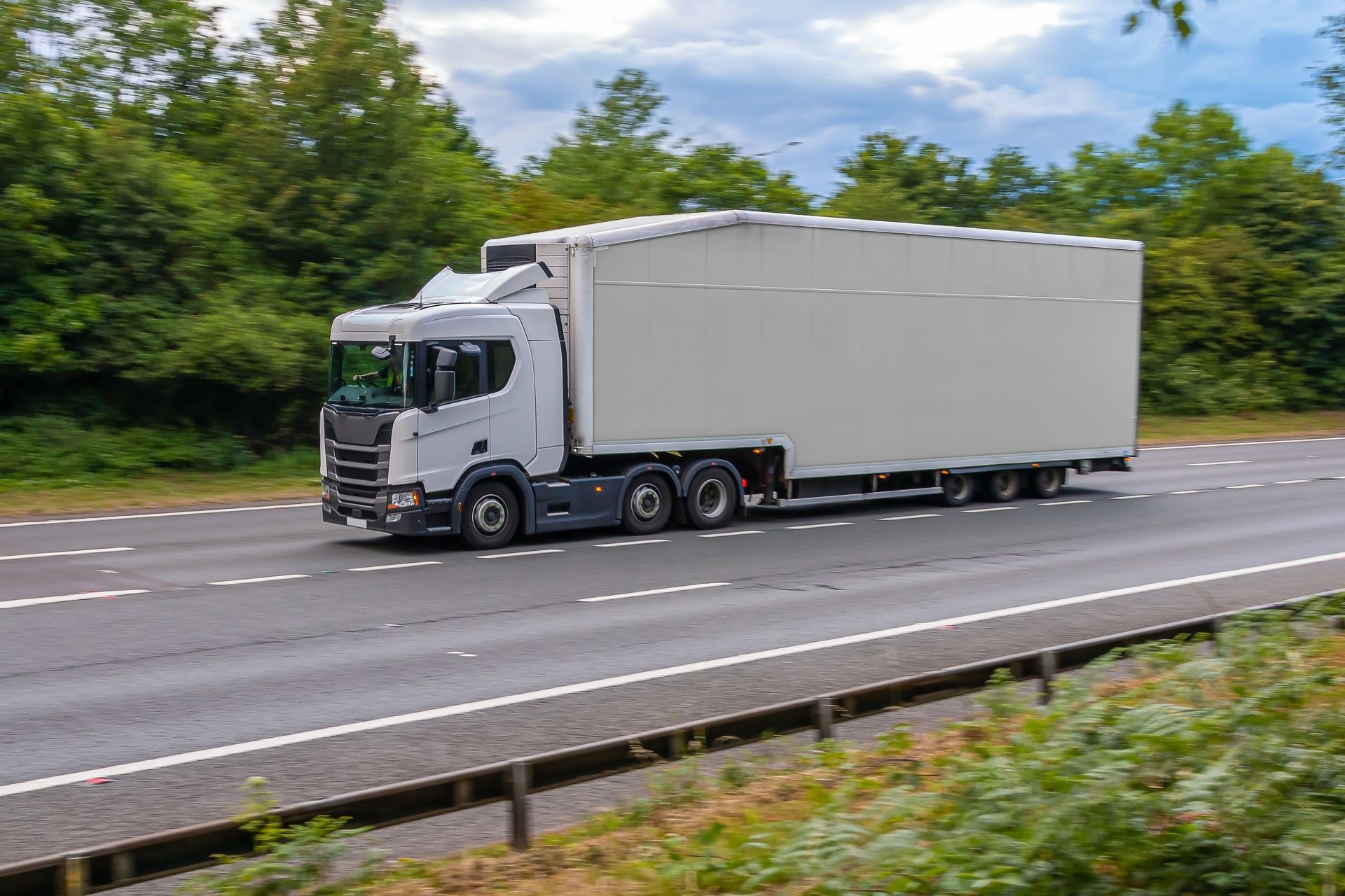 Flatbed trailer hauling oversized freight during long distance heavy haul trucking transport