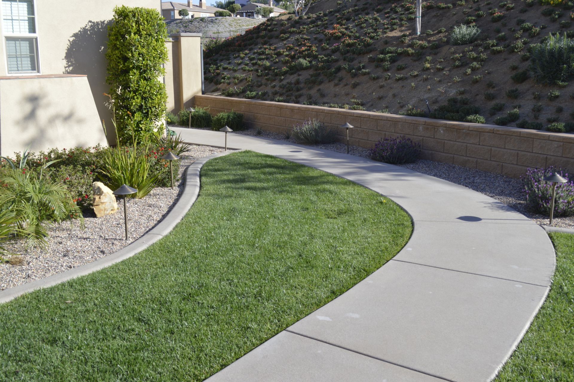 Masonry retaining wall and stone pathway built by Superior Concrete Construction, serving Corona, CA homeowners