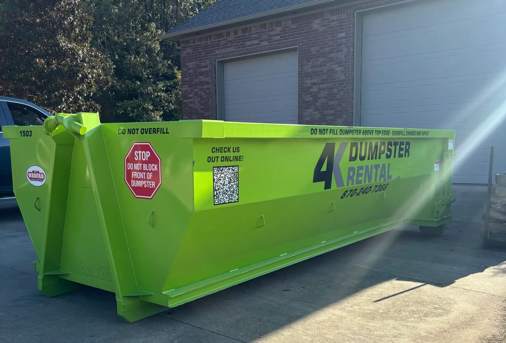 15 yard roll-off dumpster placed on a driveway in Northeast Arkansas
