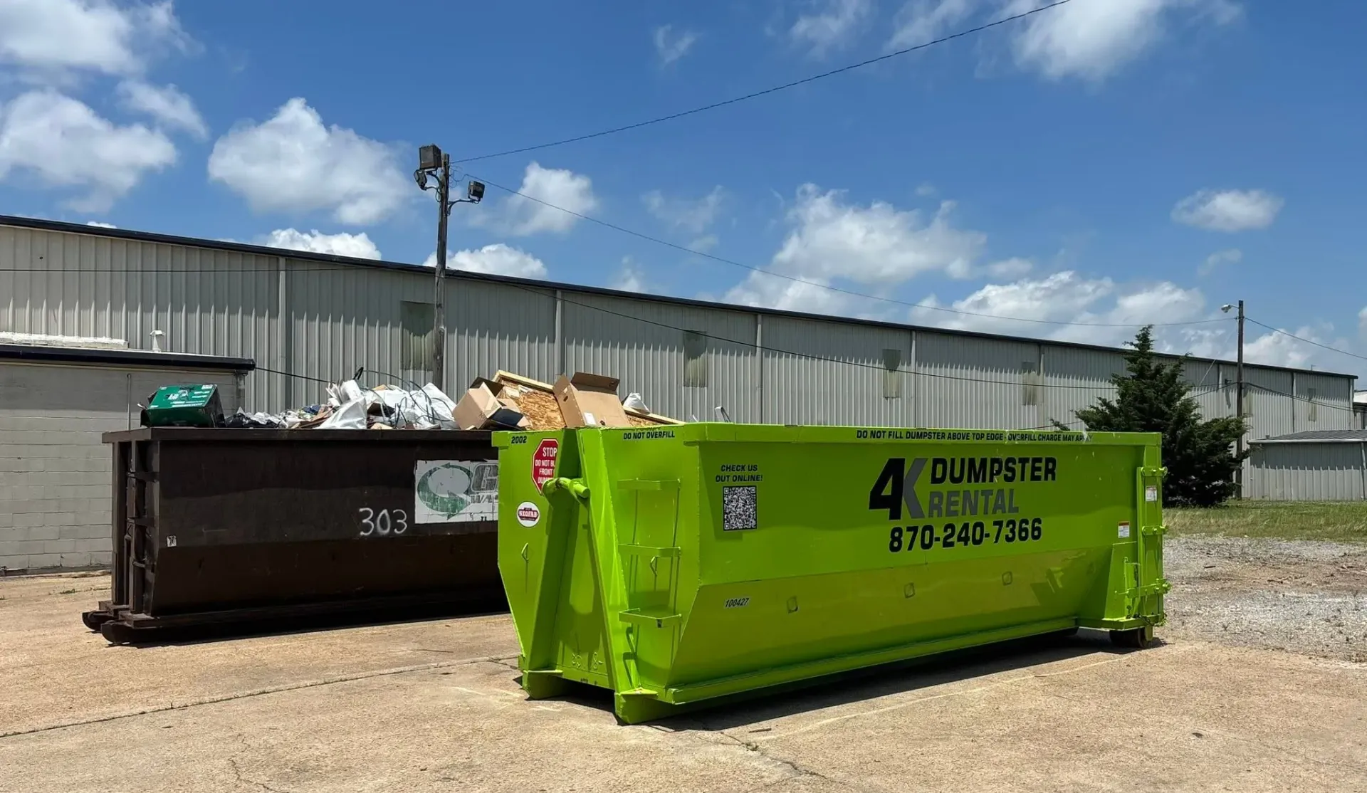 Commercial roll-off dumpster placed at a business lot in Northeast Arkansas