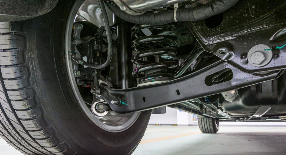 A Close Up of the Underside of a Car With a Tire and Shock Absorber — Motortorque Automotive in South Grafton, NSW