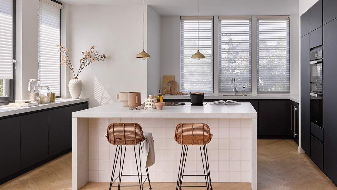 A kitchen with Duette blinds installed by Blind & Shutter City in Pretoria East adding style and warmth.