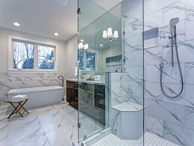 Incredible master bathroom with Carrara marble tile surround. 