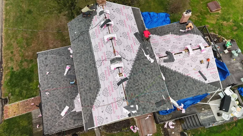 Quantum Roofing & Restoration crew installing underlayment during a roof replacement in Maryland