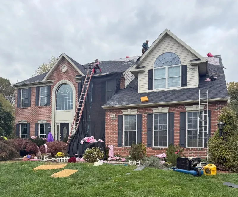 Quantum Roofing & Restoration crew replacing the roof on a brick home in Havre de Grace, MD