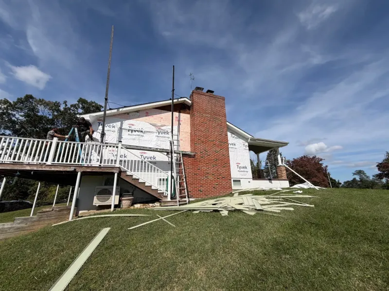 Quantum Roofing & Restoration crew completing a siding replacement on a Maryland home