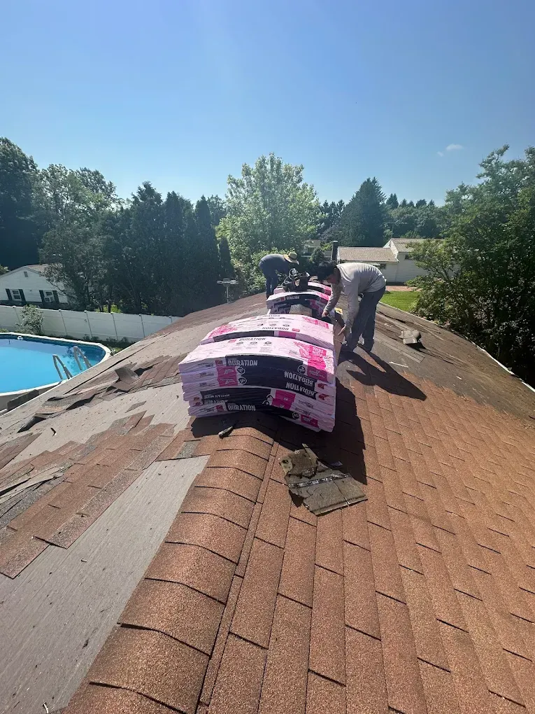 Roofing crew working on a residential roof replacement in Maryland