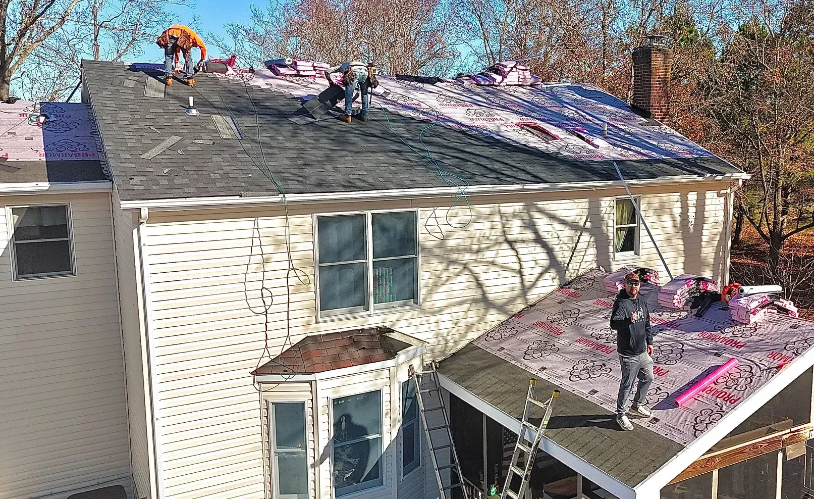 Quantum Roofing & Restoration team installing shingles during a full roof replacement in Maryland