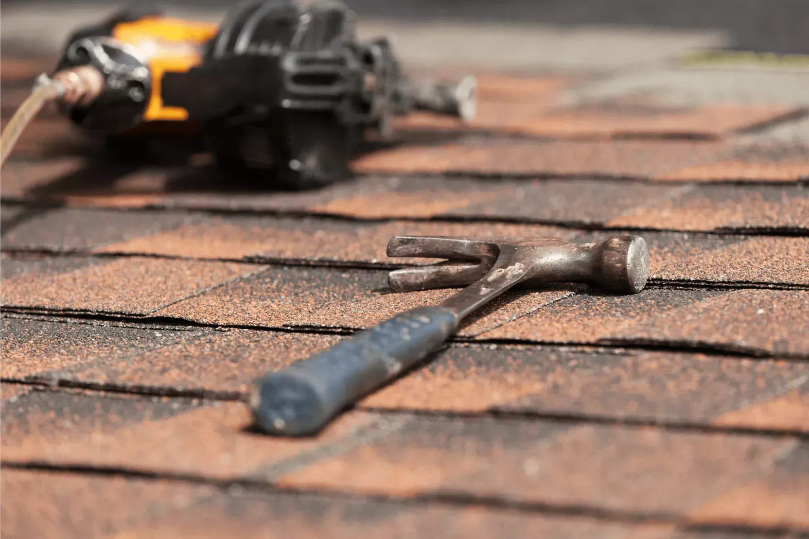 Roofing tools on asphalt shingles during a roof installation in Havre de Grace, MD