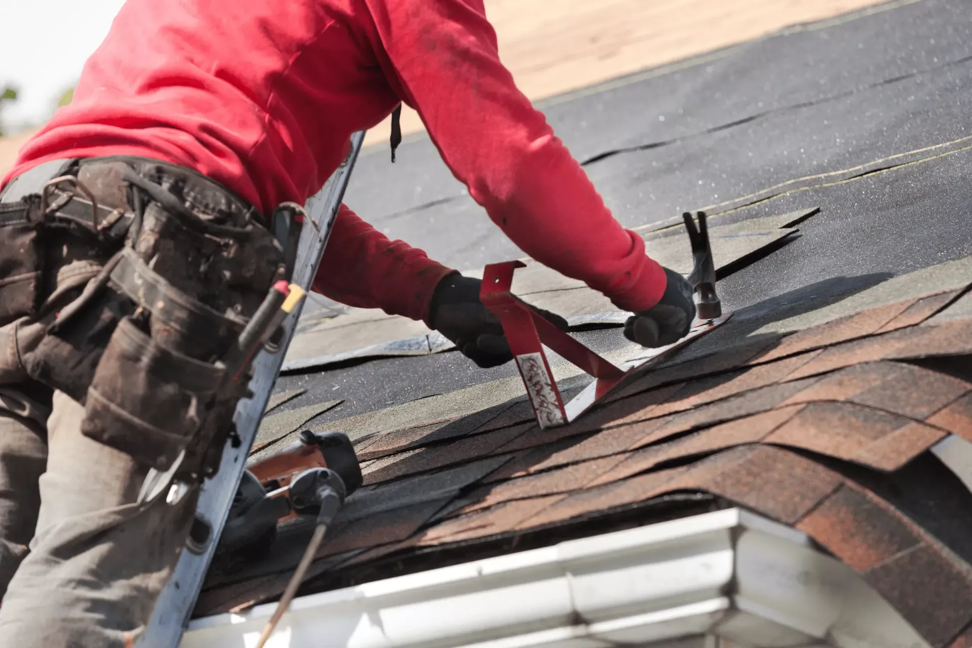 Quantum Roofing contractor repairing storm-damaged shingles on a Maryland home