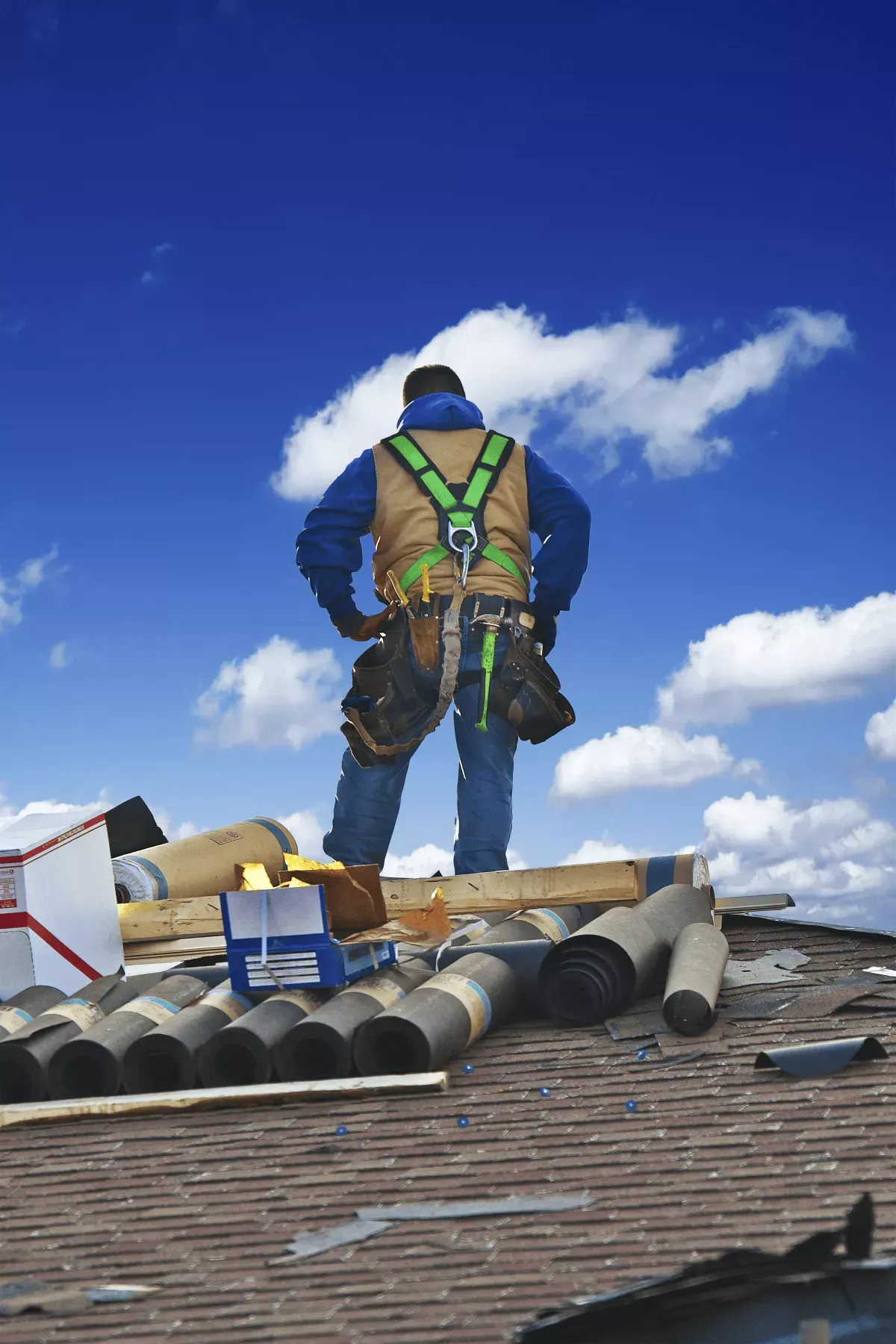 Roofing contractor on a Maryland home assessing storm damage before roof replacement