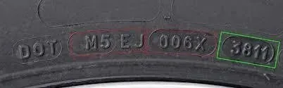 Close-up of a tire sidewall showing DOT code and the tire's manufacture date (3811), indicating the 38th week of 2011.
