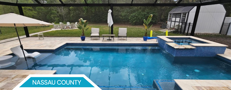 Swimming pool with blue water and surrounding patio. Nassau County.
