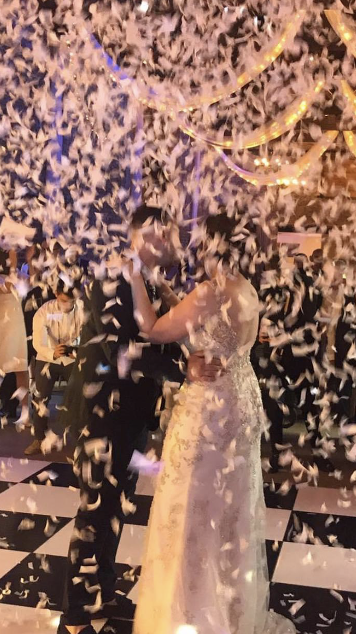 confetti or gliter canon being fired over bride and groom