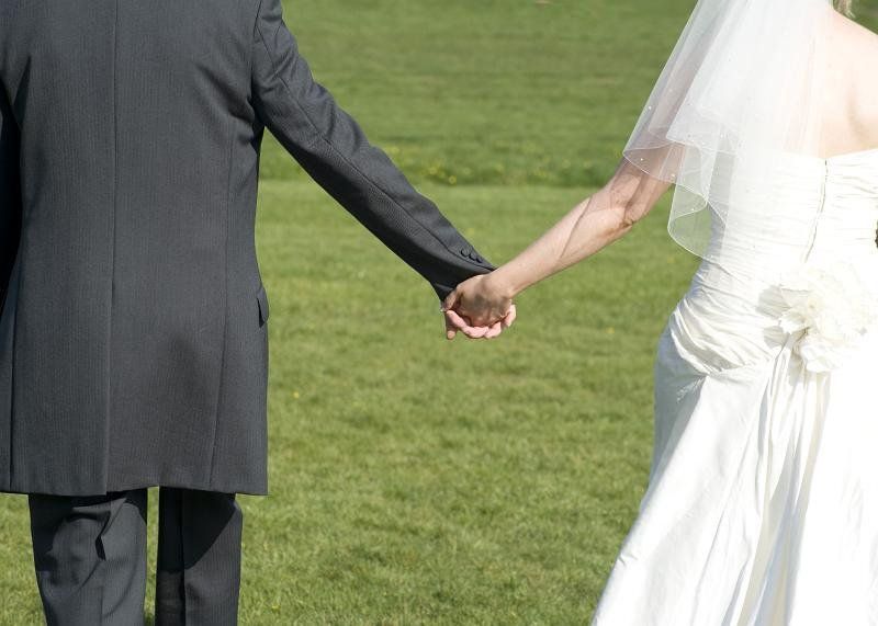 bride and groom hand-in-hand leaving the wedding ceremony