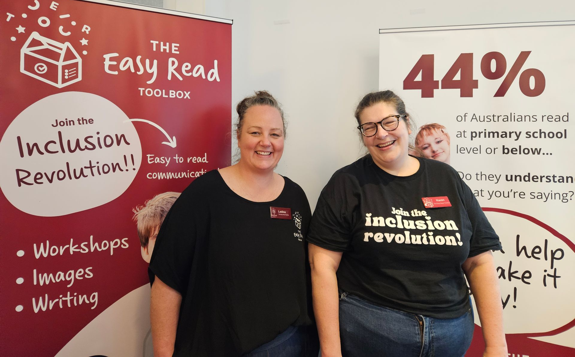 Ladina and Karen standing in front of 2 Toolbox banners.