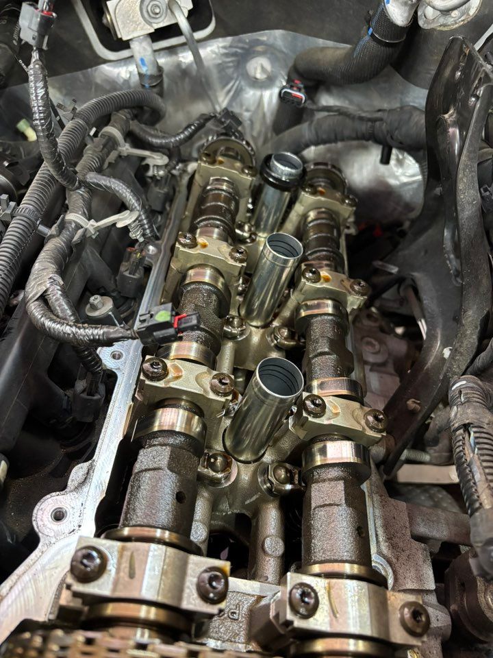Engine cylinder head with exposed camshafts and valve train.
