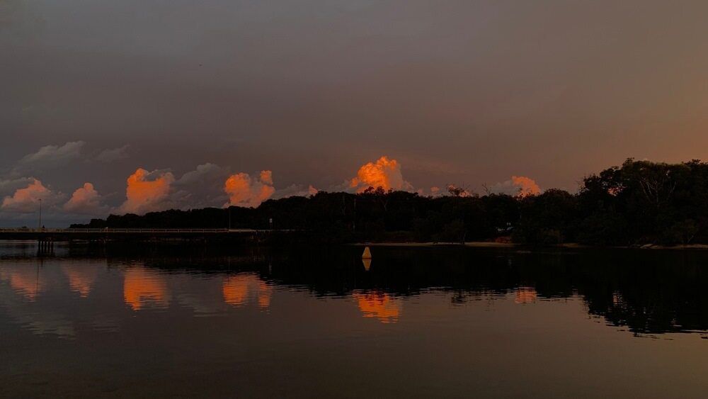 A Sunset Over A Lake With Trees In The Foreground  — Kingscliff Tweed Coast Taxis Pty Ltd In Pottsville, NSW