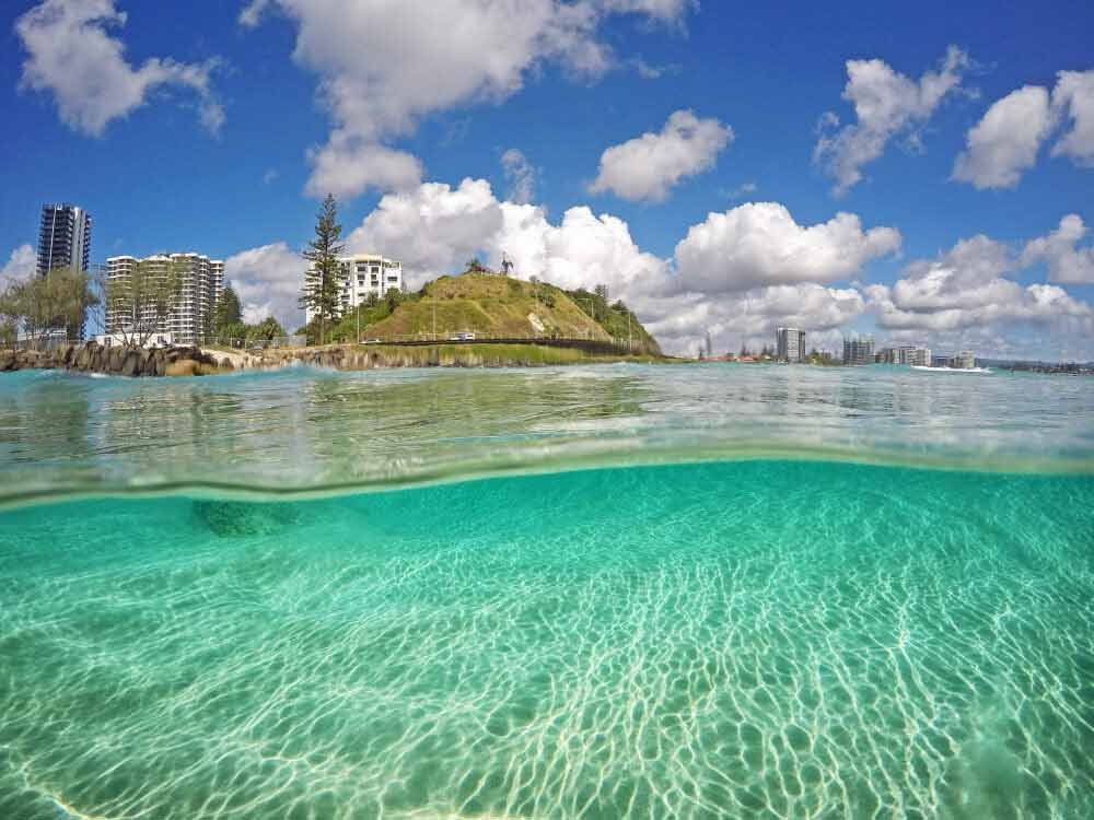 A Half Underwater View Of A Beach With A City In The Background — Kingscliff Tweed Coast Taxis Pty Ltd In Coolangatta, NSW