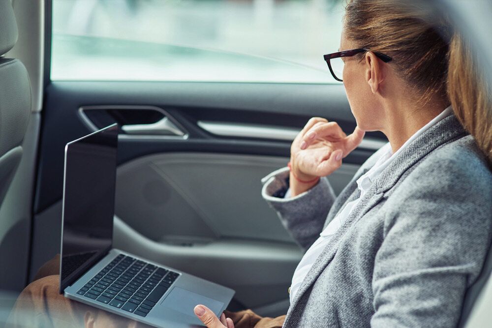 A Woman Is Sitting In The Back Seat Of A Car — Kingscliff Tweed Coast Taxis Pty Ltd In Kingscliff, NSW