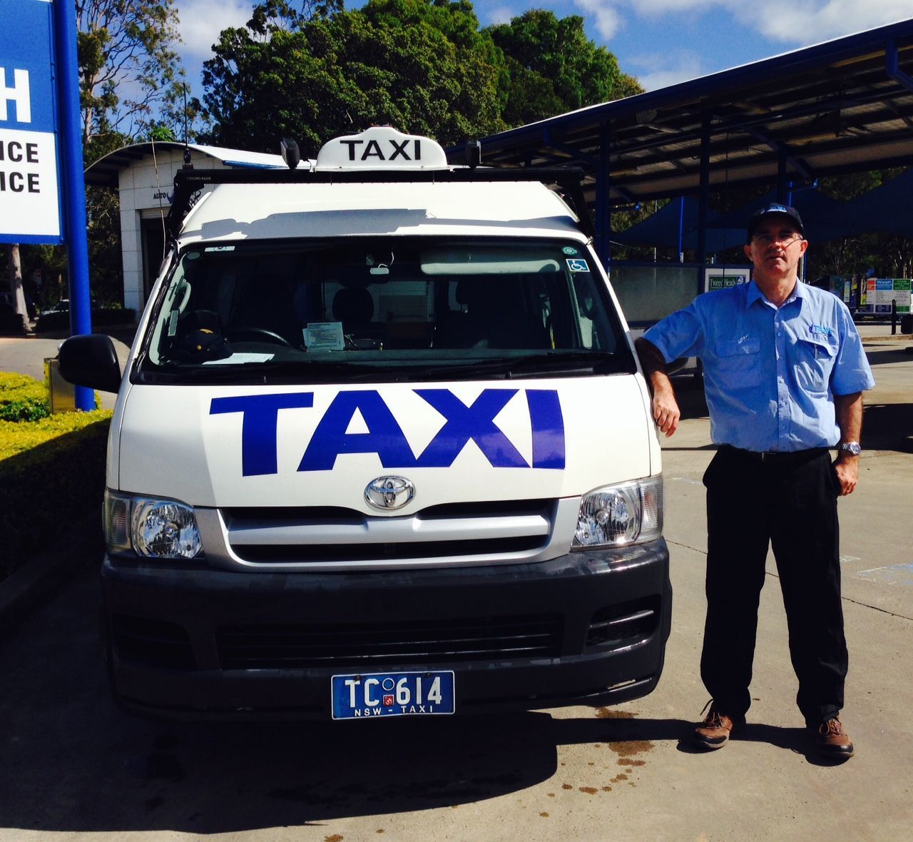 A Taxi Sign On Top Of A Car In A City — Kingscliff Tweed Coast Taxis Pty Ltd In Tweed Heads, NSW