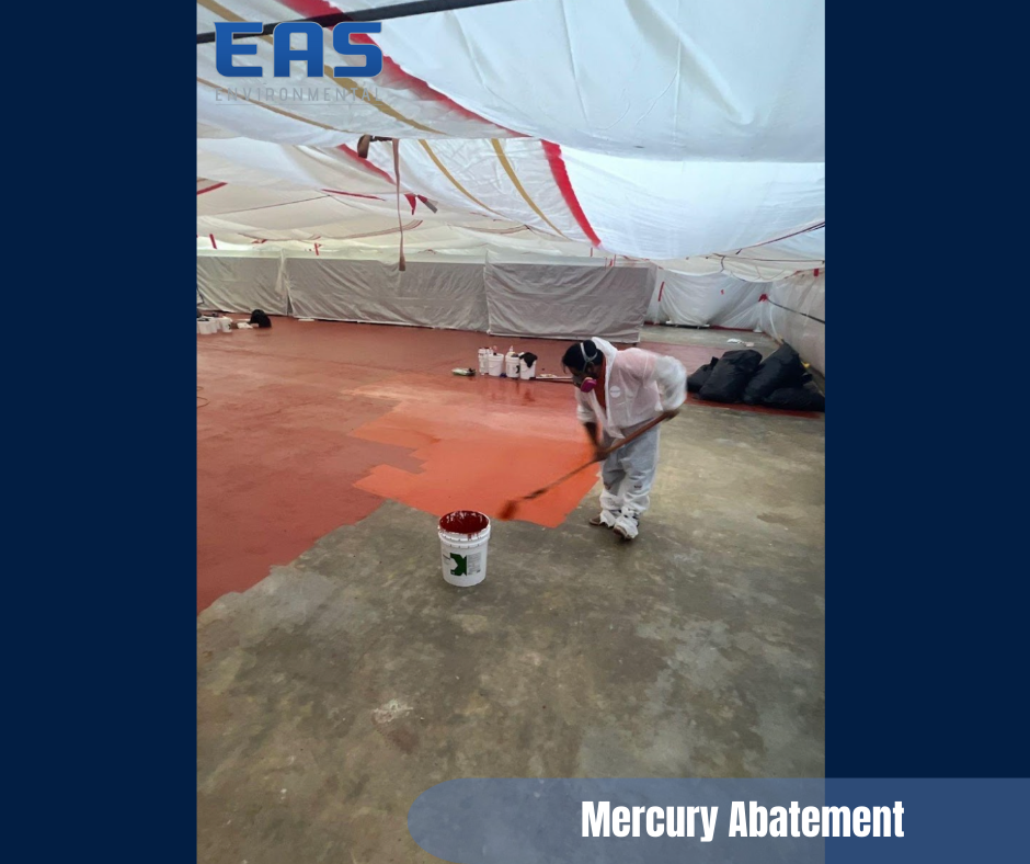 Person in protective suit painting red floor; mercury abatement in progress.