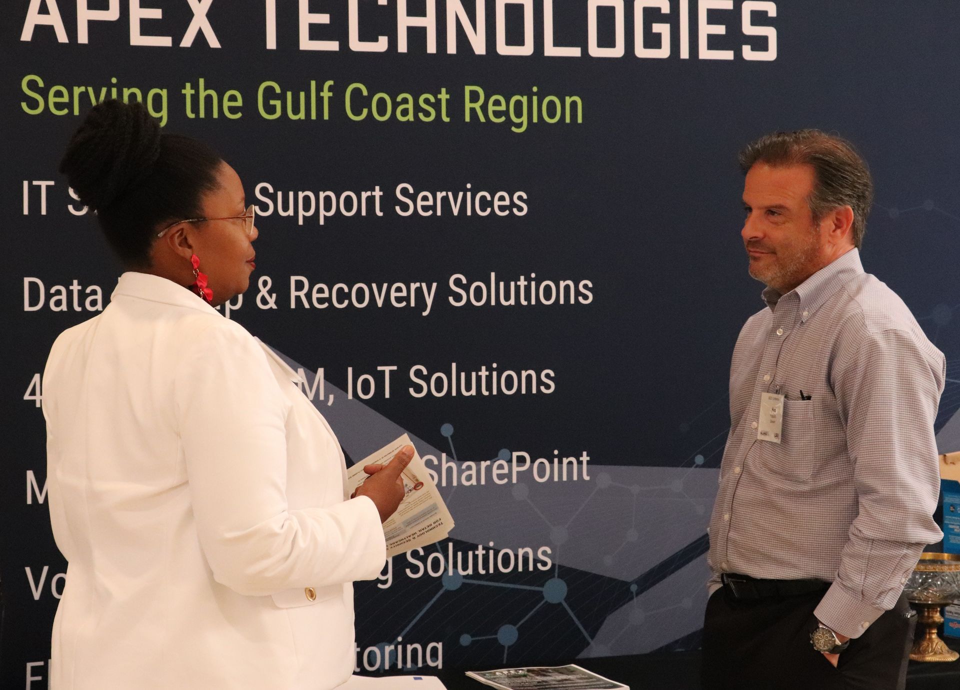 Ned Fasullo with Velocity Partners Group meeting with clients at a conference.