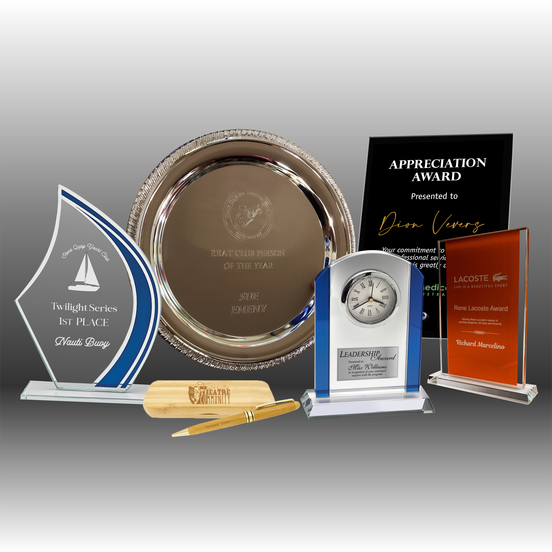 Various awards and desk accessories, including a silver tray, clock, and engraved plaques — NQ Plaques & Trophies In Mount Isa, QLD
