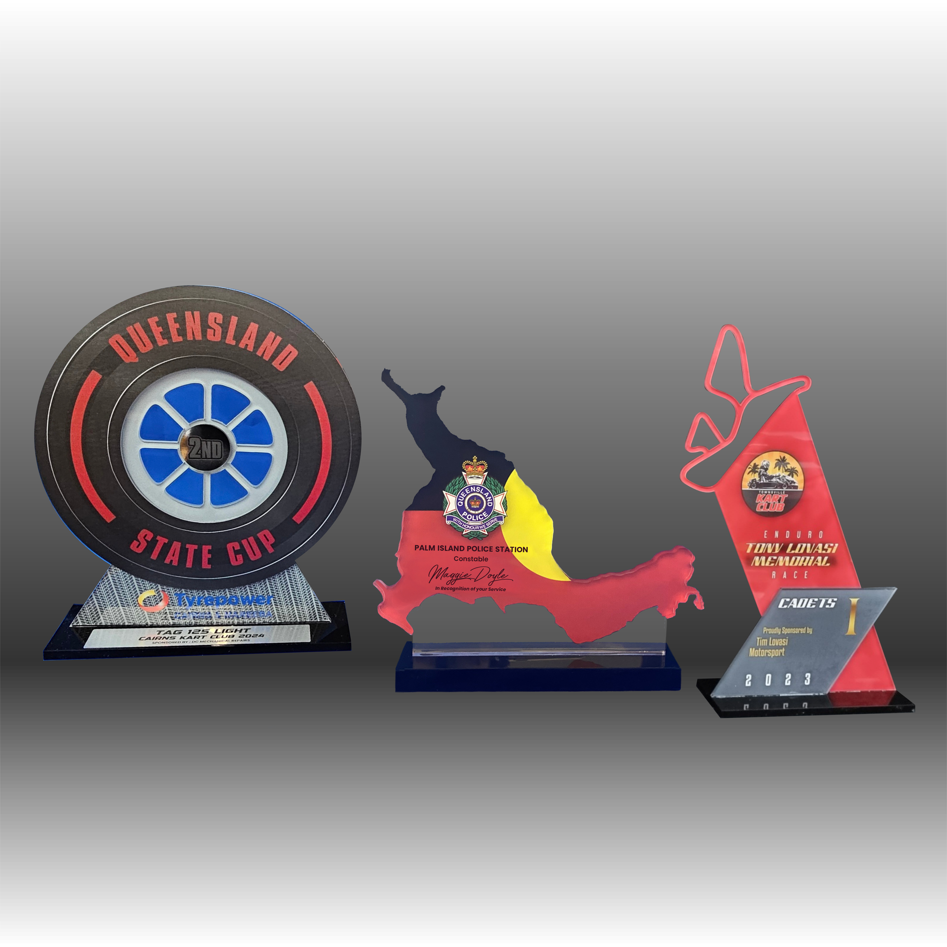 Various awards and desk accessories, including a silver tray, clock, and engraved plaques — NQ Plaques & Trophies In Mount Isa, QLD