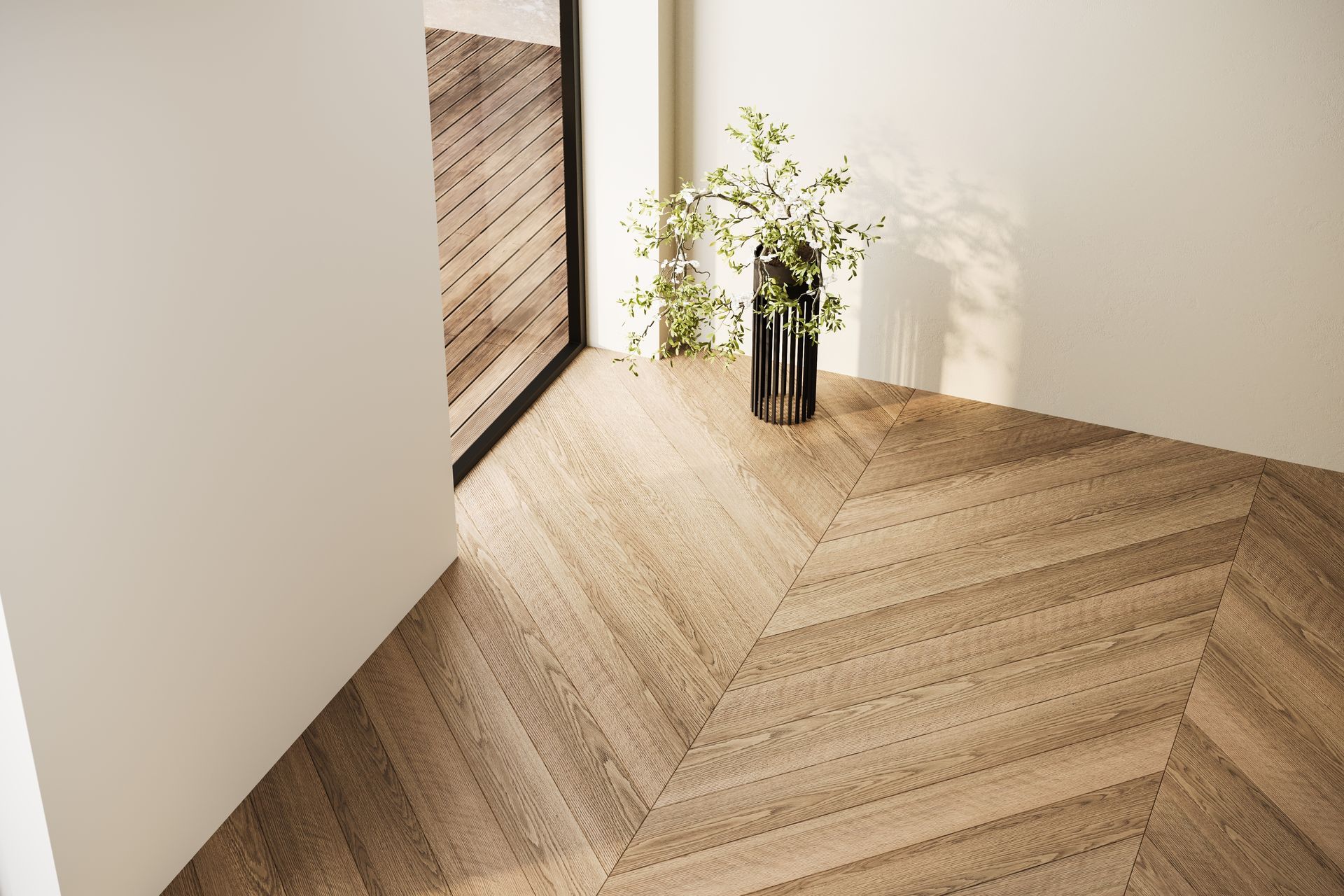 Minimalist room corner with light wood herringbone floor, white walls, and a vase of flowers by a window