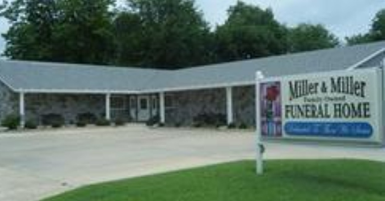Miller & Miller Funeral Home building with sign, white exterior and green lawn