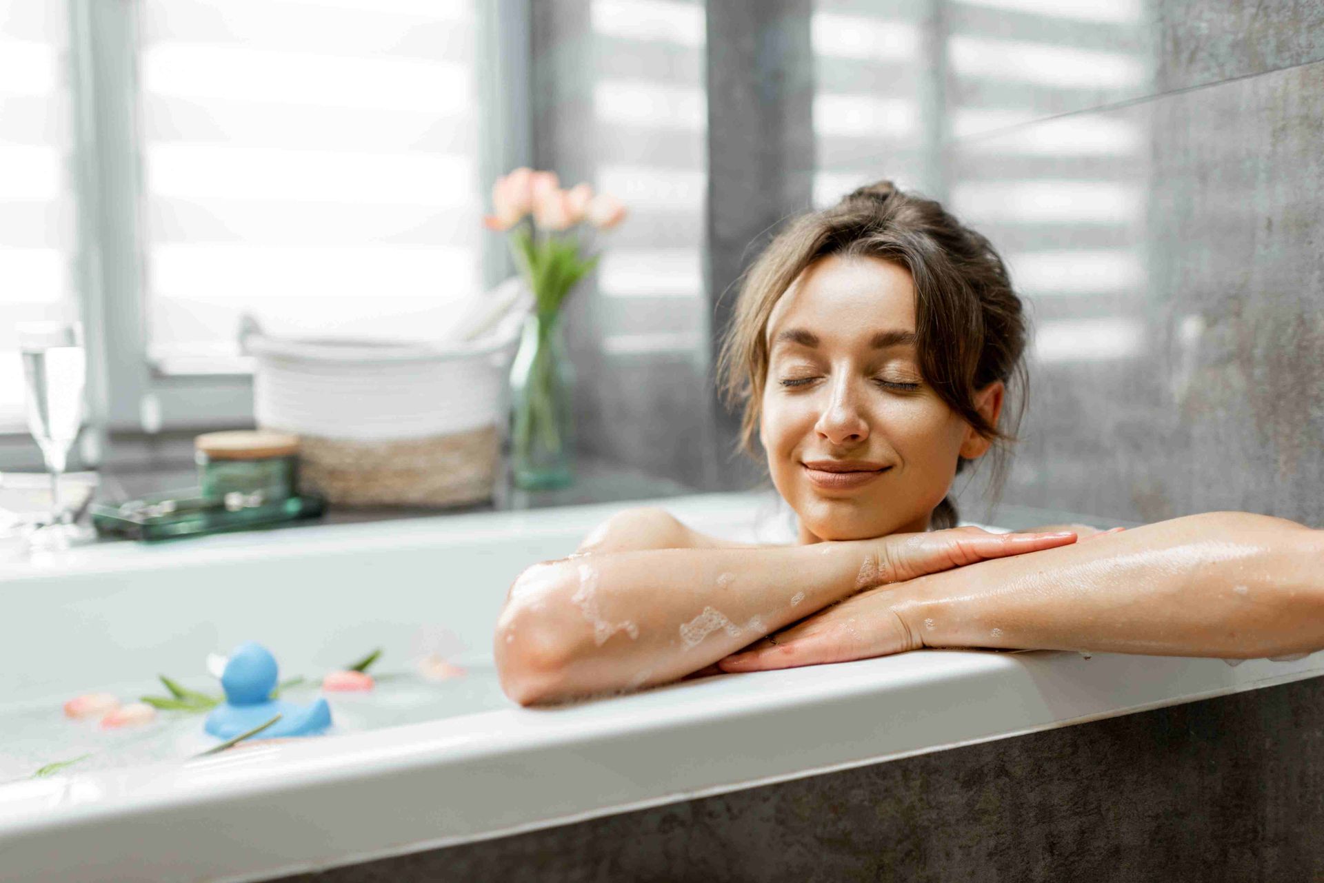 A woman in a bath, smiling