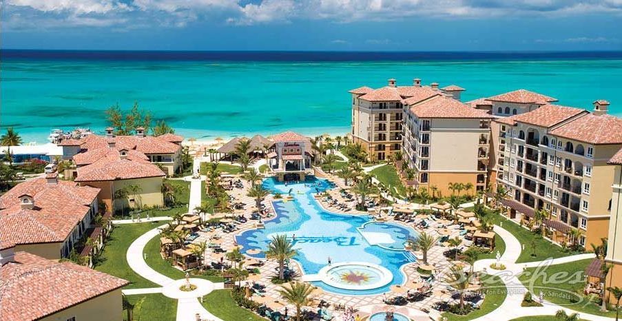 An aerial view of a resort with a large pool in the middle of it.