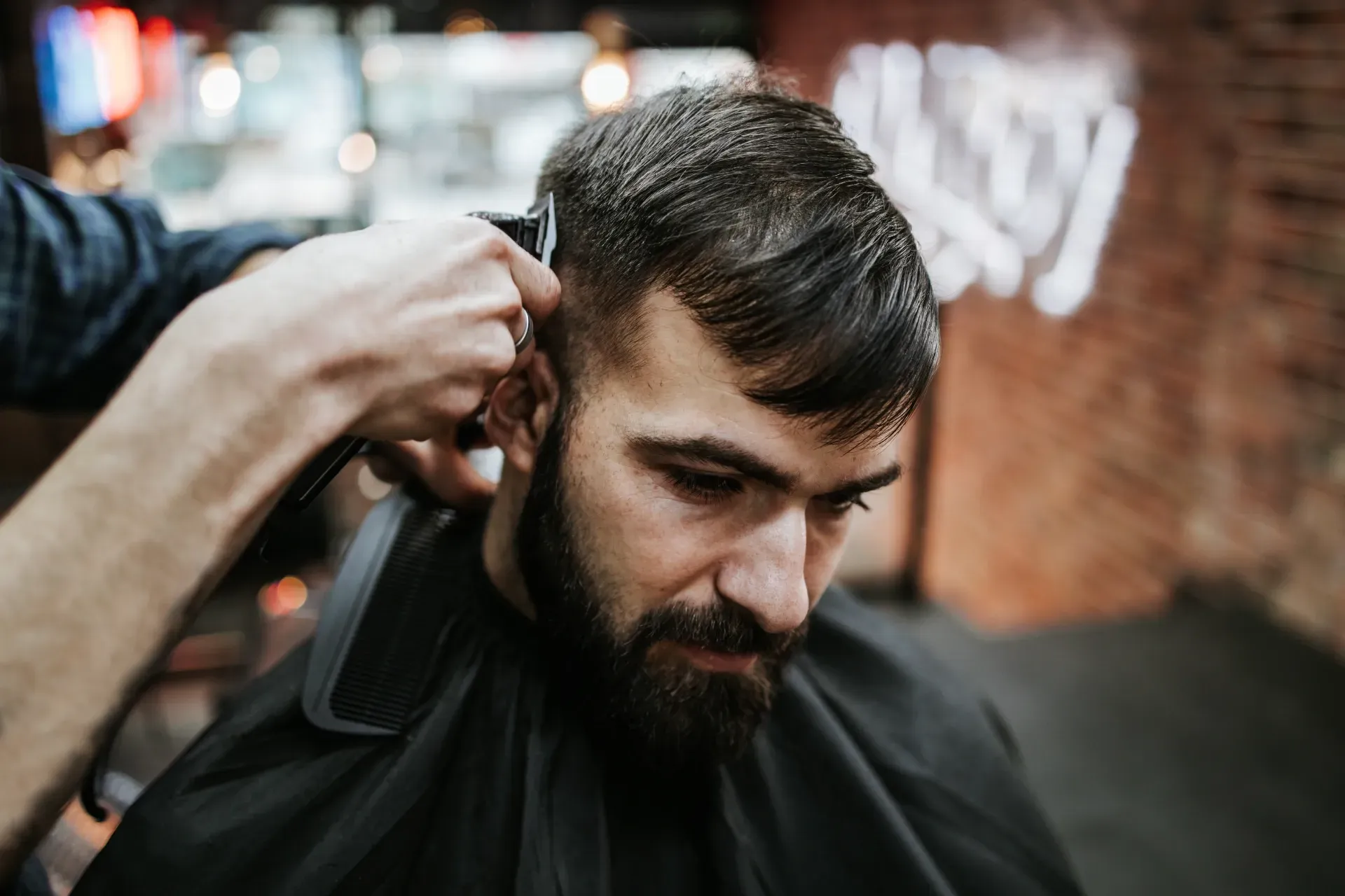 Barber Trimming a Man’s Hair and Beard — Ultimate Barber in Maryborough, QLD