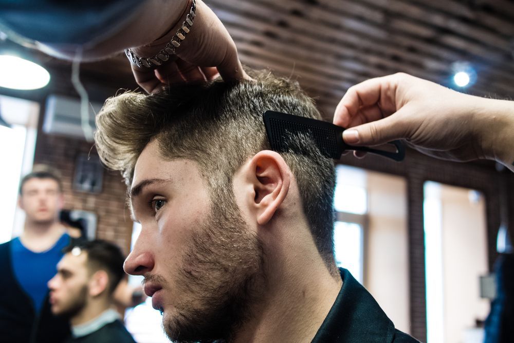 Barber Trimming a Man’s Hair with Clippers — Ultimate Barber in Maryborough, QLD