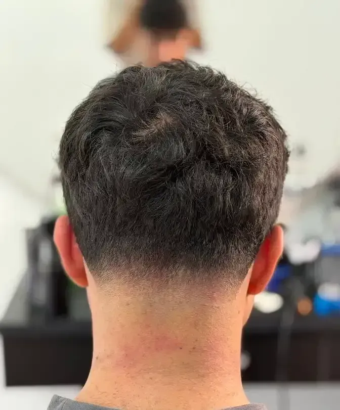 Back view of a short dark haircut with a skin fade in a barbershop — Ultimate Barber in Maryborough, QLD