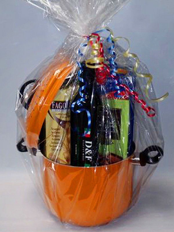An orange pot filled with food and a bottle of d & f