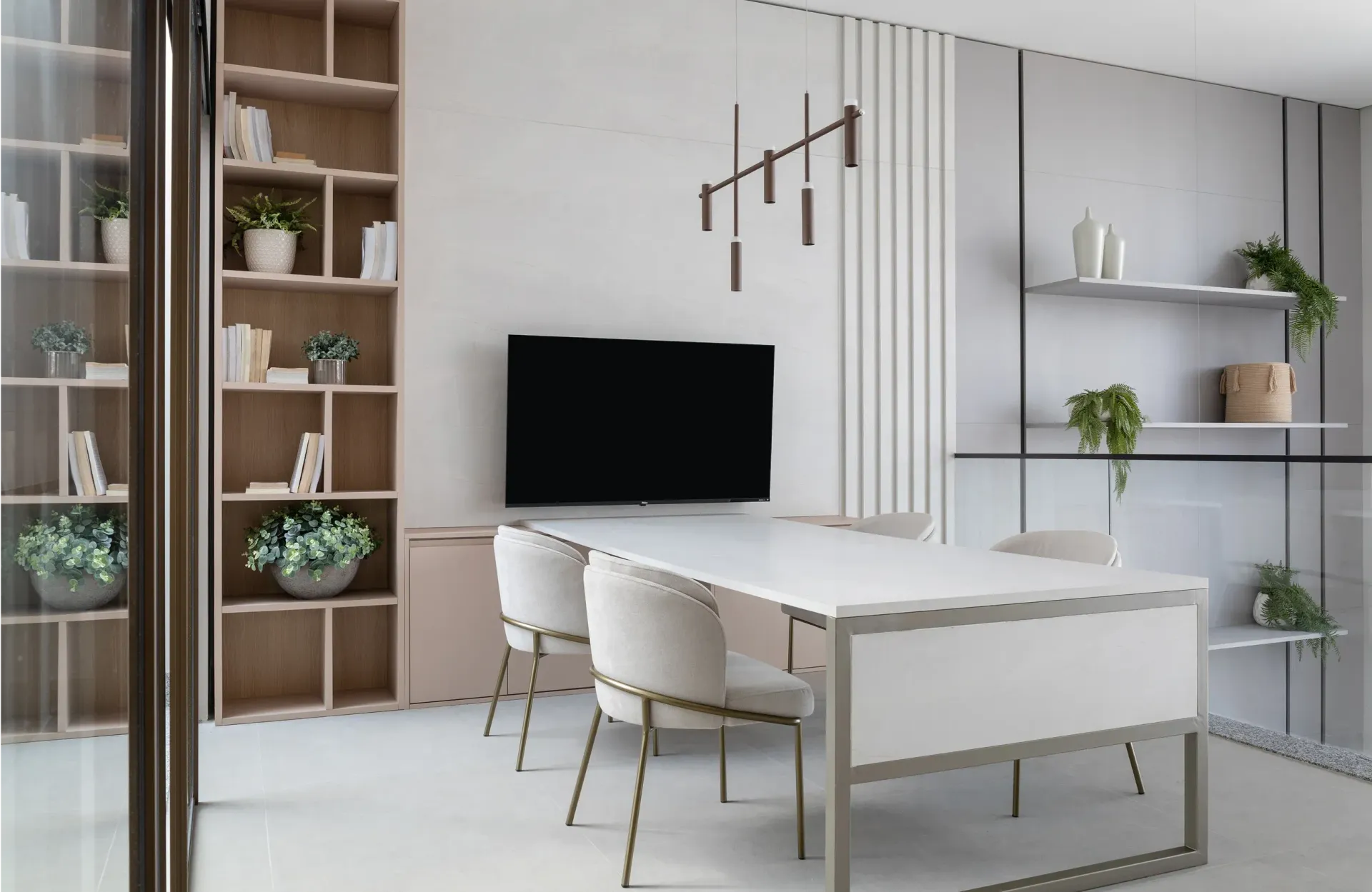 Oficina moderna blanca con escritorio, sillas, televisor montado en la pared, estantes y plantas en macetas.