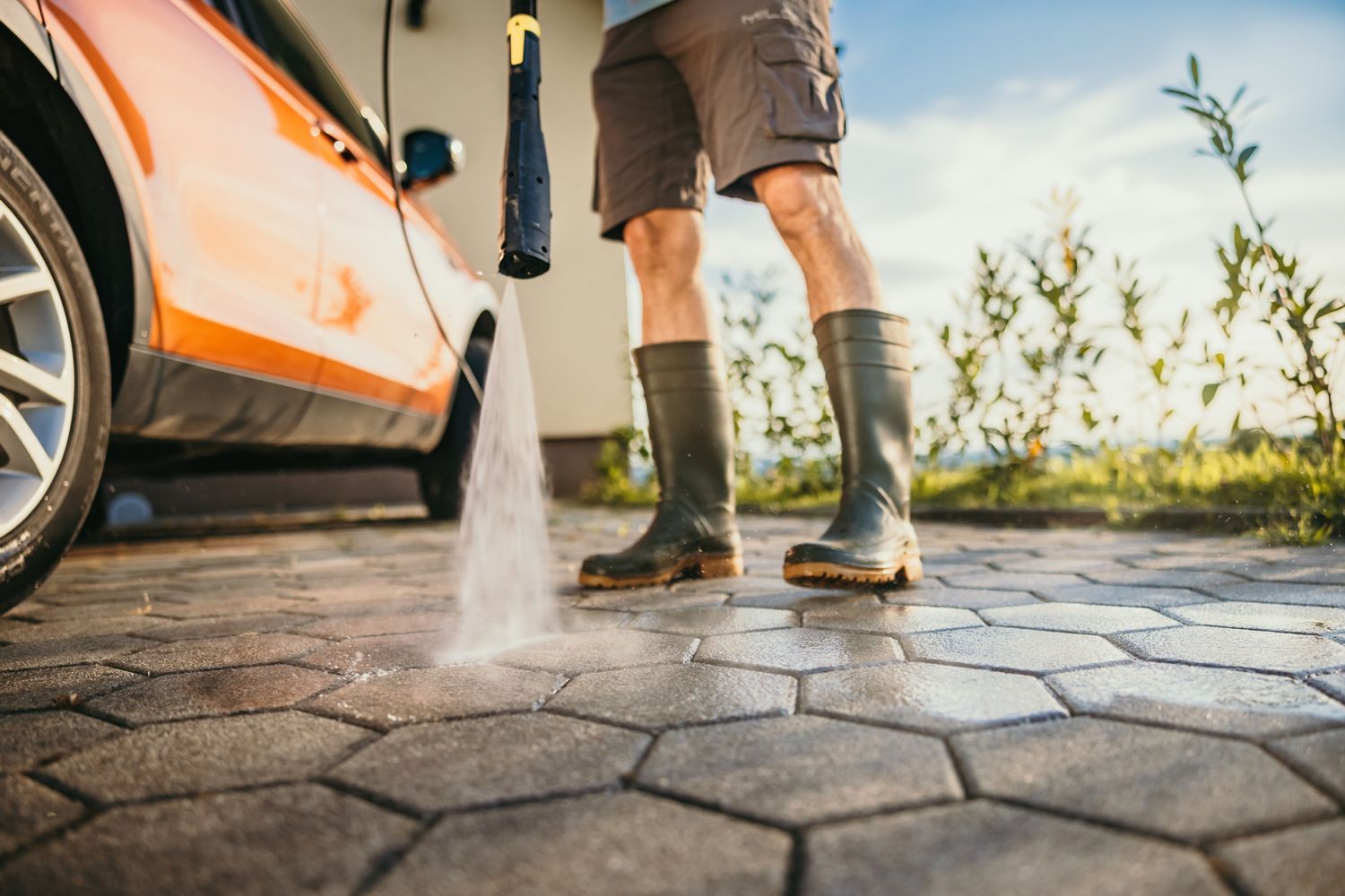 Man In Boots Cleaning Garage — Seguin, TX — Ewald's Soft Wash & Pressure Washing