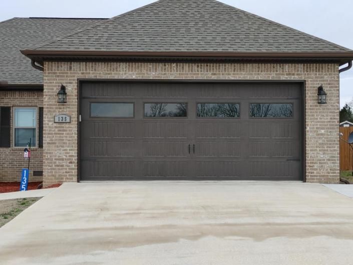 Modern brick house with a two-car garage and light concrete driveway