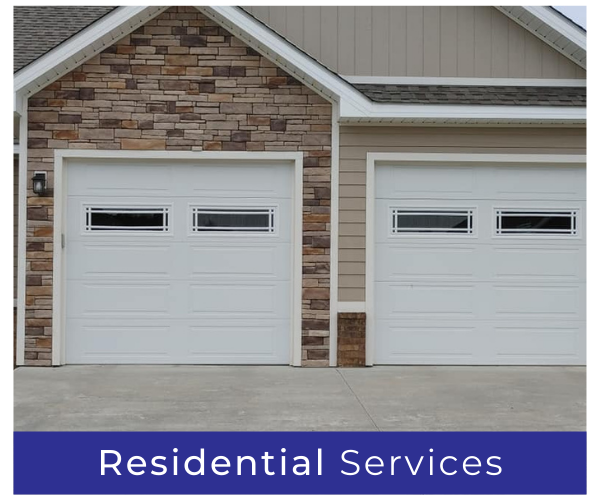 Two white garage doors on a stone-front house with a blue “Residential Services” banner