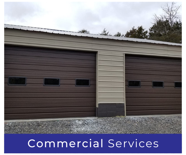 Two brown garage doors on a beige commercial building with a blue “Commercial Services” sign
